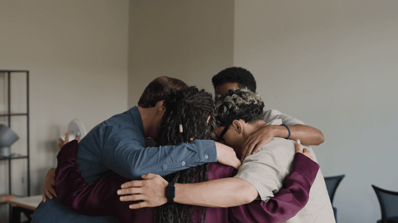 A group of friends in a supportive group hug